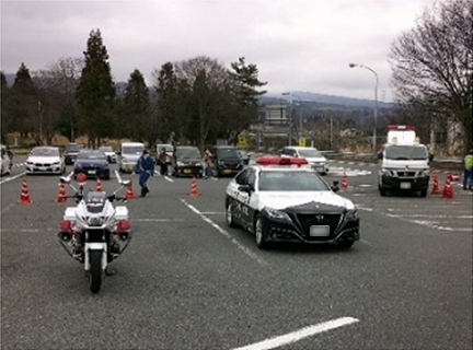 Image of police motorcycle and patrol car