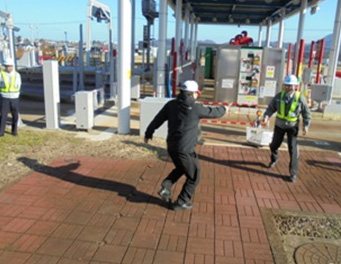 Image image of simulated criminal attacking toll gate staff